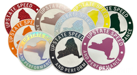 Various colors of round, vinyl, 6 inch Upstate Speed logo stickers.